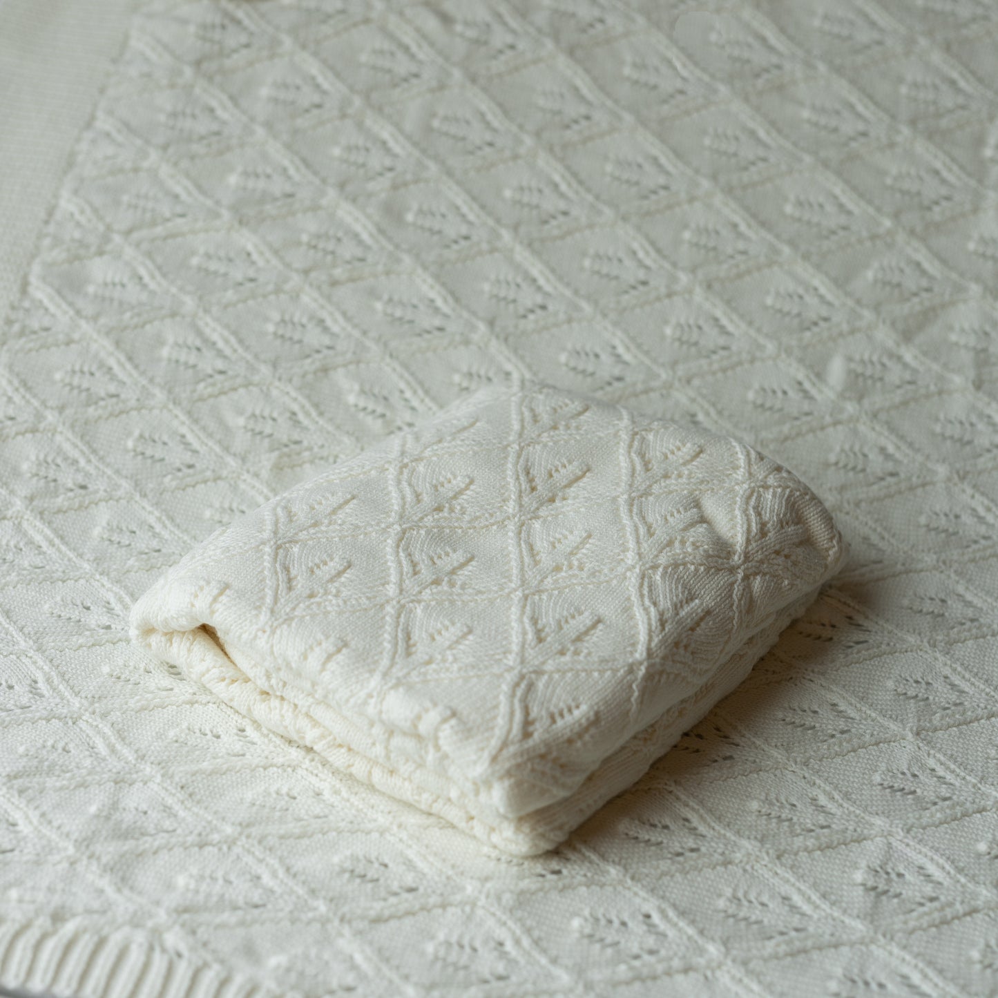 white knit blanket layer or backdrop