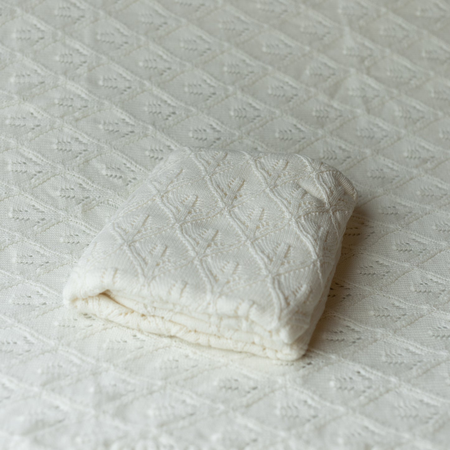 white knit blanket layer or backdrop