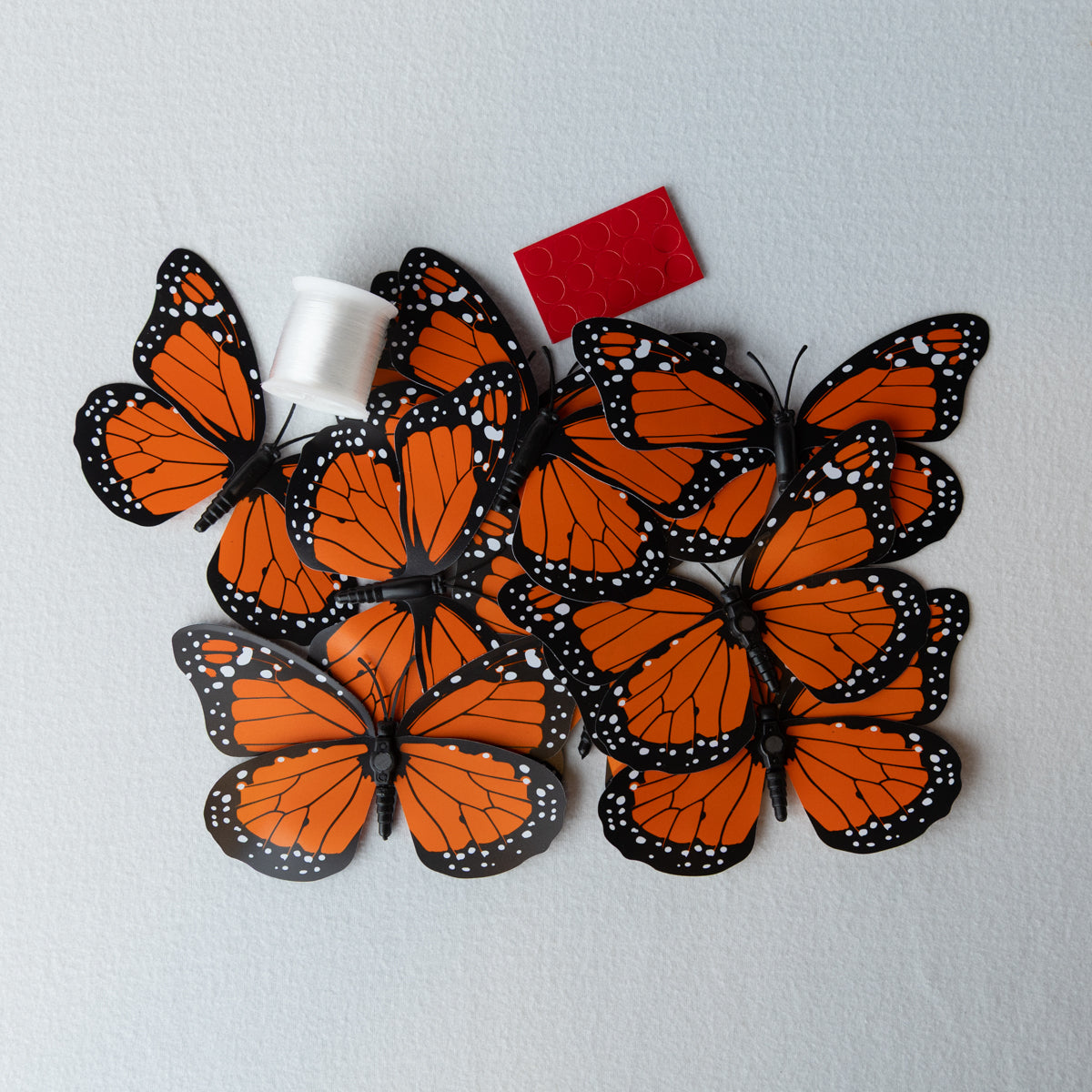12 butterflies in orange or pink plus fishing line and sticky squares